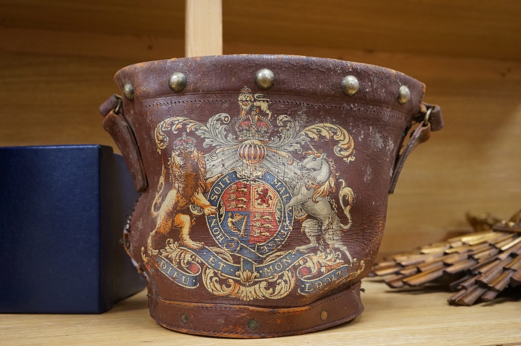 A brown leather fire bucket with Royal Coat of Arms decoration, 25cm high